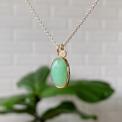 Long oval rose cut chrysoprase in yellow gold bezel pendant paired with a yellow gold engraved diamond pendant on a silver chain.