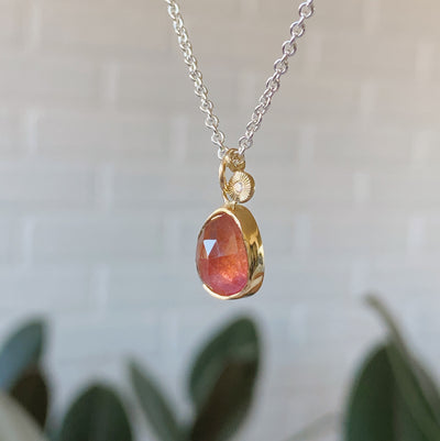 Freeform rose cut pink tourmaline 14k yellow gold Theia necklace with an engraved white diamond side pendant on a silver chain side view