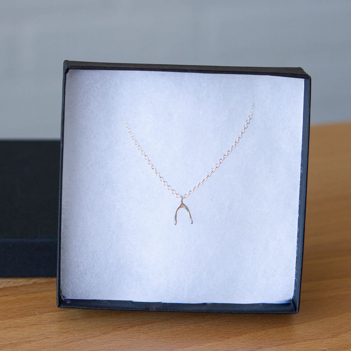 Silver Wishbone Necklace by Corey Egan in a gift box