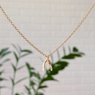 Vermeil Wishbone Necklace by Corey Egan side view in natural light