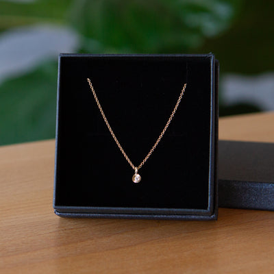 Gold and Diamond Rise Necklace in packaging 