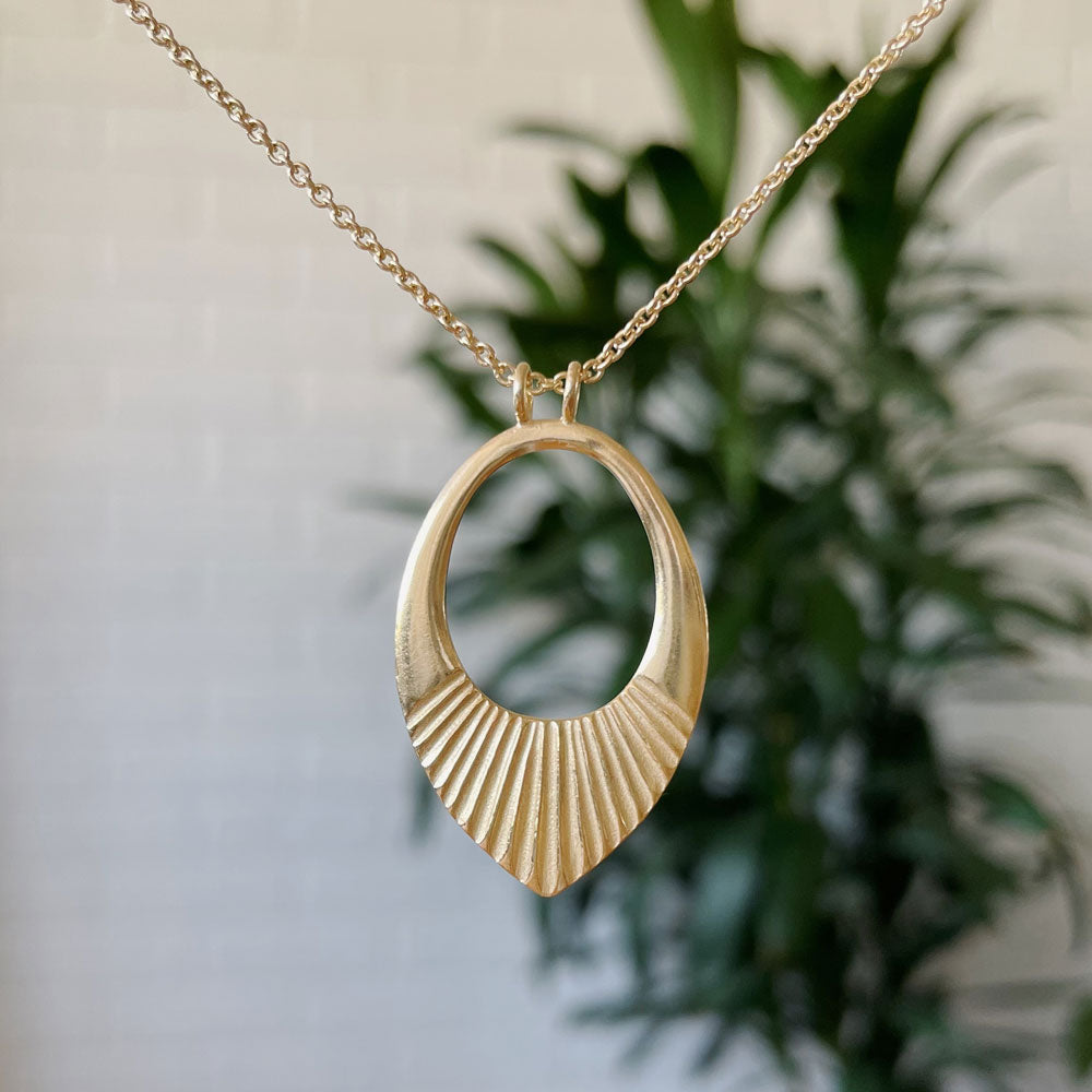 Gold vermeil medium open petal shape pendant with a textured bottom on a 22" vermeil chain