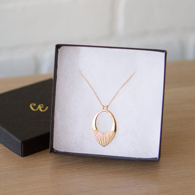 Gold vermeil medium open petal shape pendant with a textured bottom on a 22" vermeil chain in a gift box