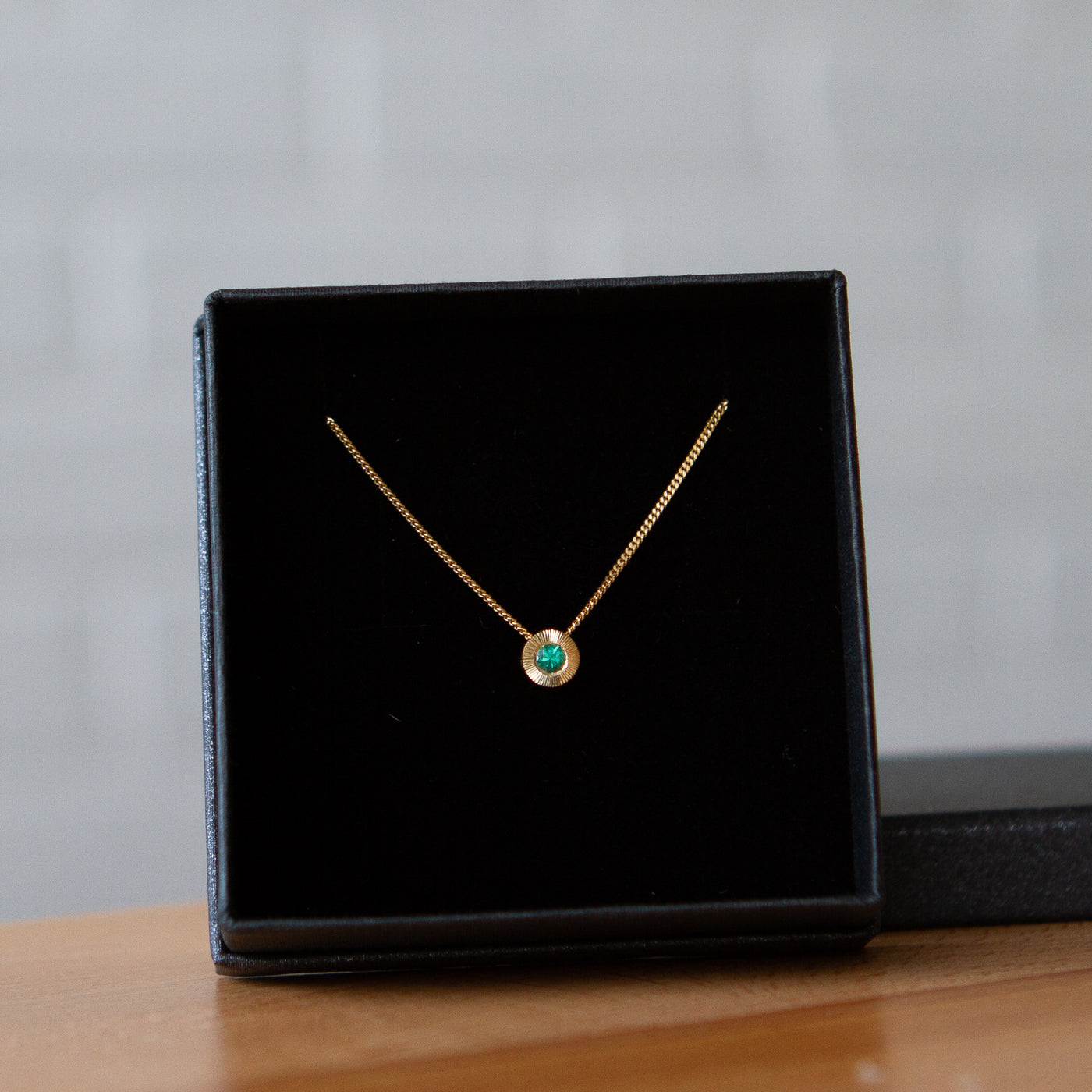 May birthstone Aurora slide necklace with emerald in yellow gold in a gift box