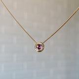 October birthstone 14k yellow gold Aurora necklace with pink tourmaline center and engraved sunburst halo border.