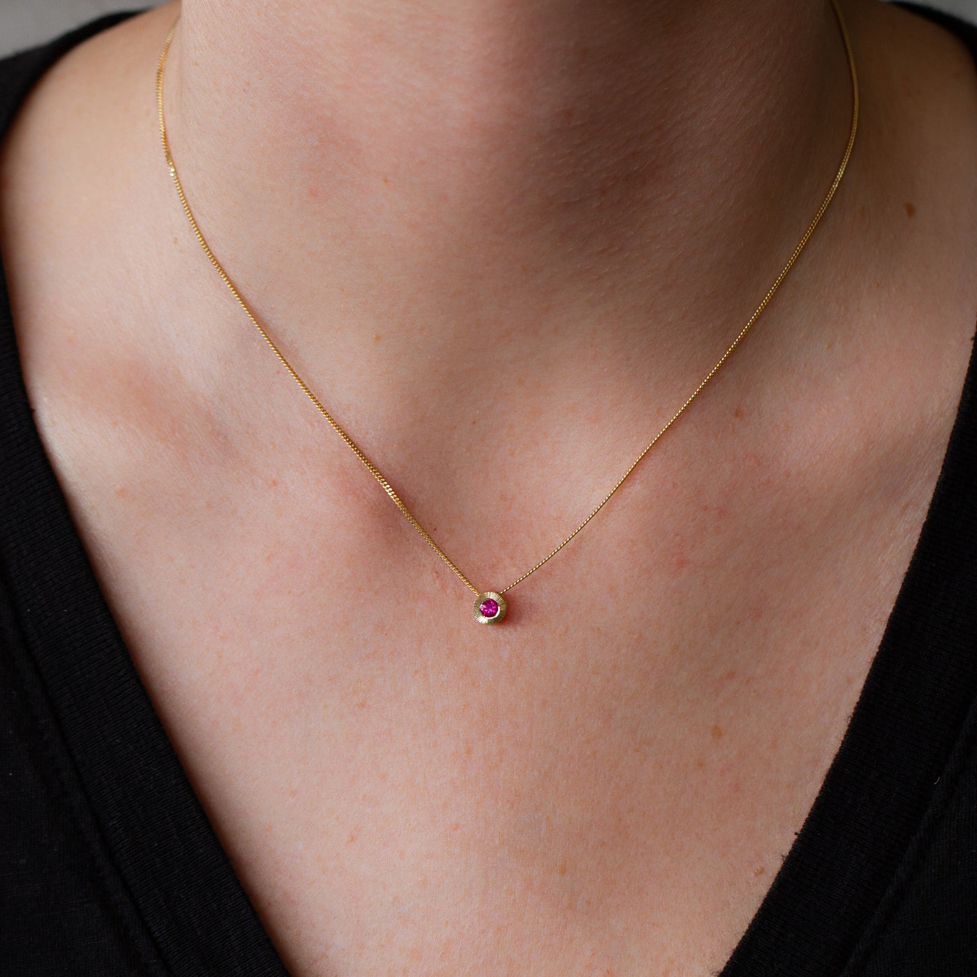 July birthstone Aurora slide necklace with ruby in yellow gold on a neck