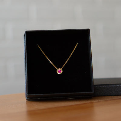 July birthstone Aurora slide necklace with ruby in yellow gold in a gift box
