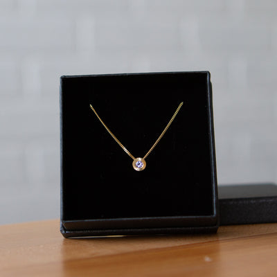 December birthstone Aurora necklace with tanzanite in yellow gold in a gift box