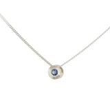 Side view sterling silver small aurora necklace with a blue Montana sapphire center on a white background 