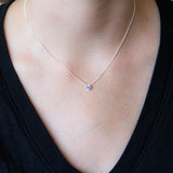 Sterling silver small aurora necklace with a blue Montana sapphire center around a neck