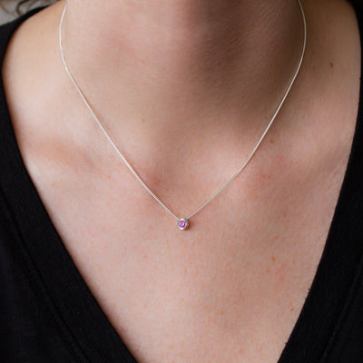 July birthstone Aurora slide necklace with ruby in silver on a neck