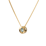 Side view 14k yellow gold Medium aurora necklace with a light teal Montana sapphire center on a white background