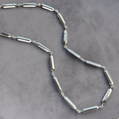 Fragment Link Necklace in Silver on neutral gray background
