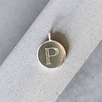 Sterling silver round pendant with an engraved block letter P