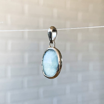 Oval Rose cut cloudy aquamarine in a sterling silver bezel pendant with a faceted silver bail alternate view