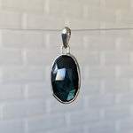 Large oval rose cut labradorite pendant crafted from sterling silver with a faceted silver bail
