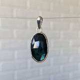 Large oval rose cut labradorite pendant crafted from sterling silver with a faceted silver bail