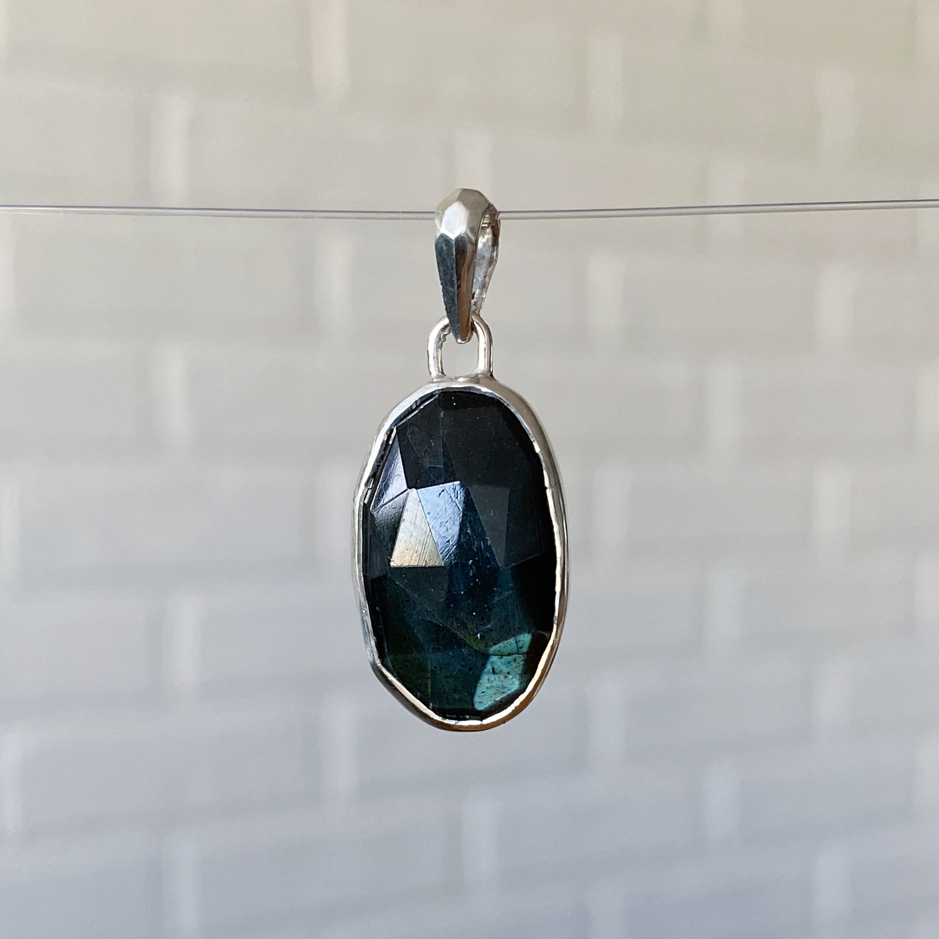 Large oval rose cut labradorite pendant crafted from sterling silver with a faceted silver bail