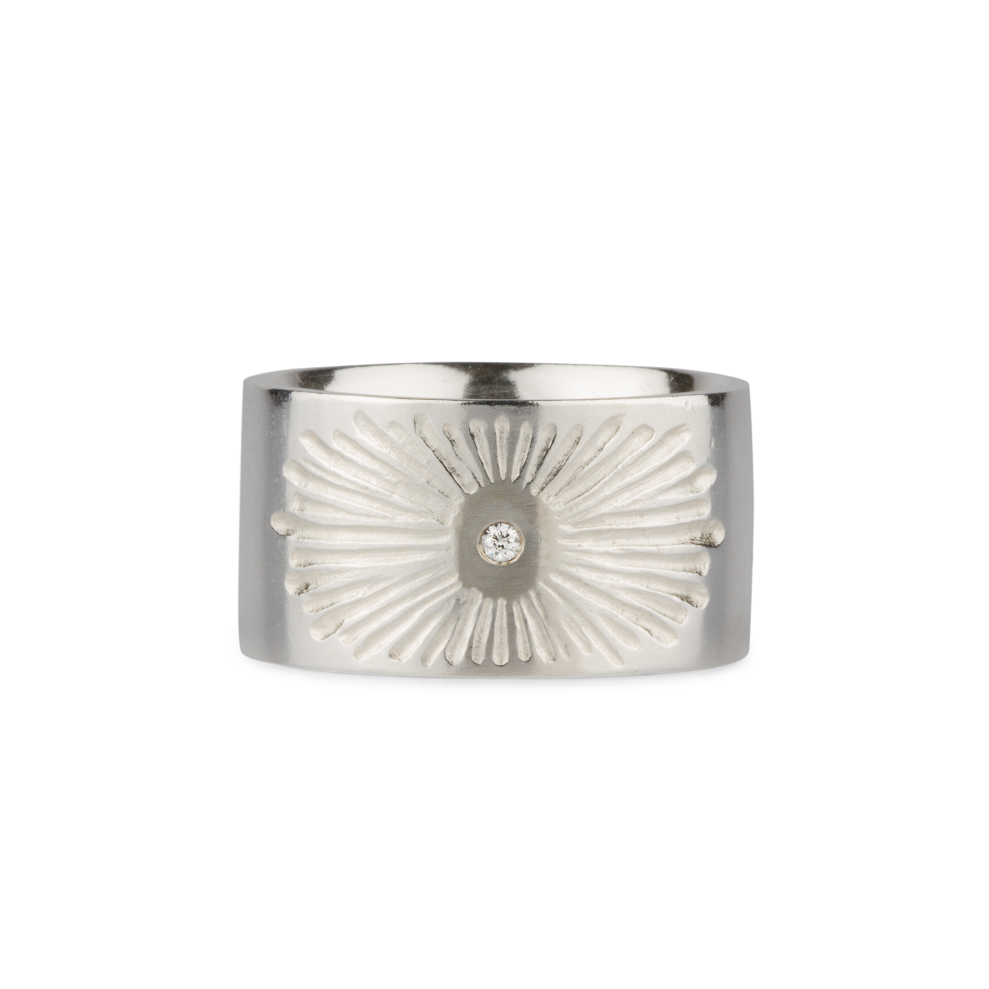 Sterlign silver wide band with single diamond and a carved sunburst design on a white background by Corey Egan