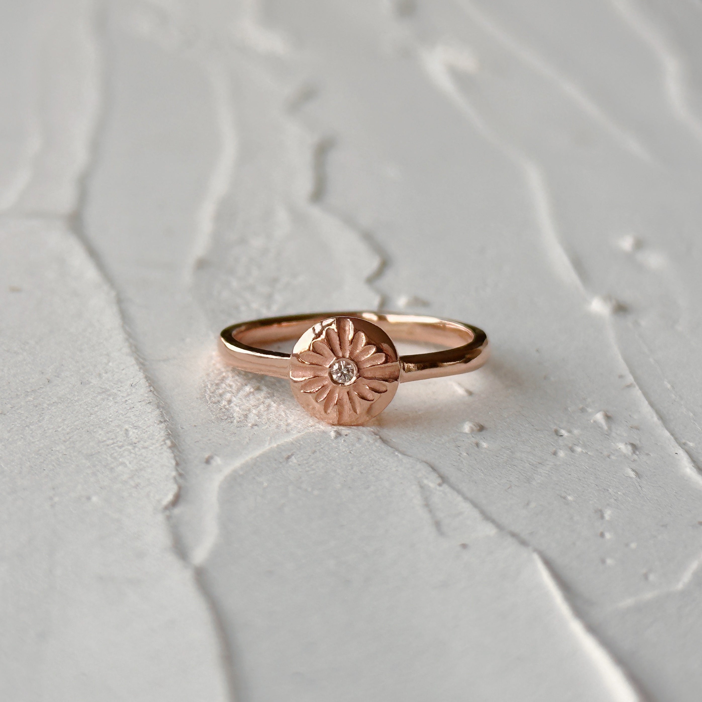 Lucia Small Rose Gold and Diamond Ring on a natural looking background
