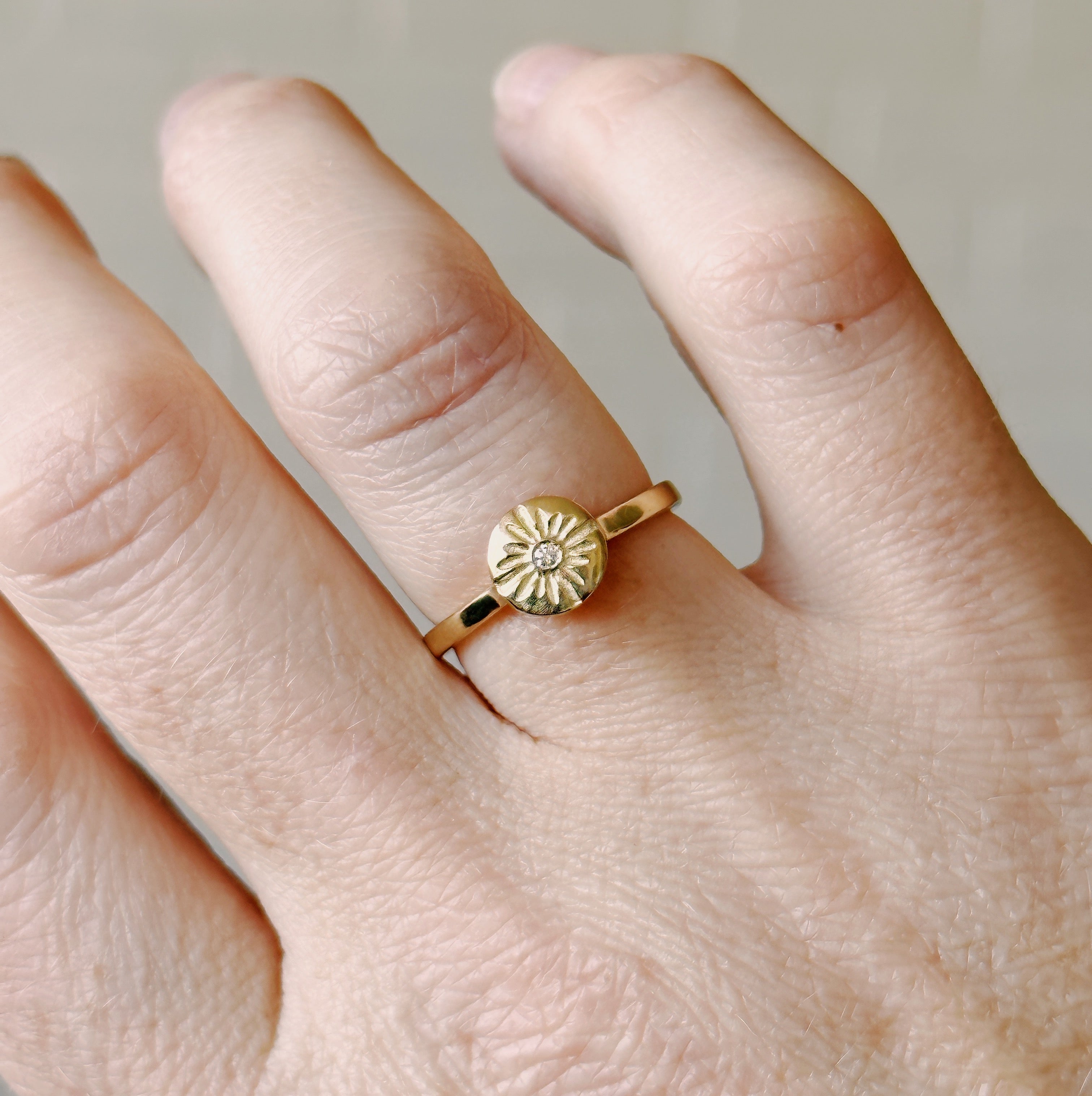 Lucia Small Yellow Gold and Diamond Ring modeled on a hand