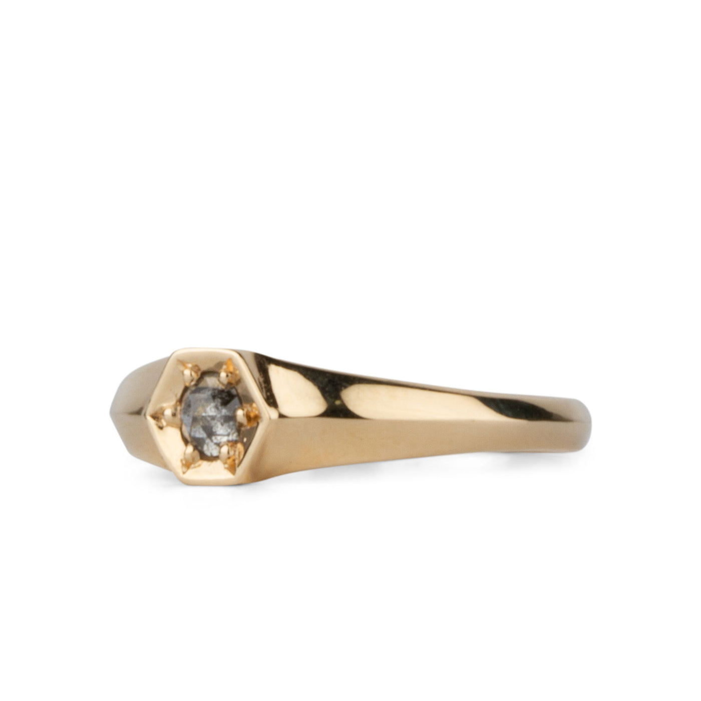 Side view of Yellow gold signet ring with bead set rose cut salt and pepper diamond on a white background