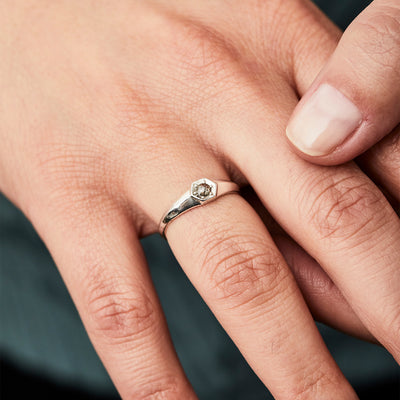 Sterling silver signet ring with bead set rose cut salt and pepper diamond on a hand alternate view