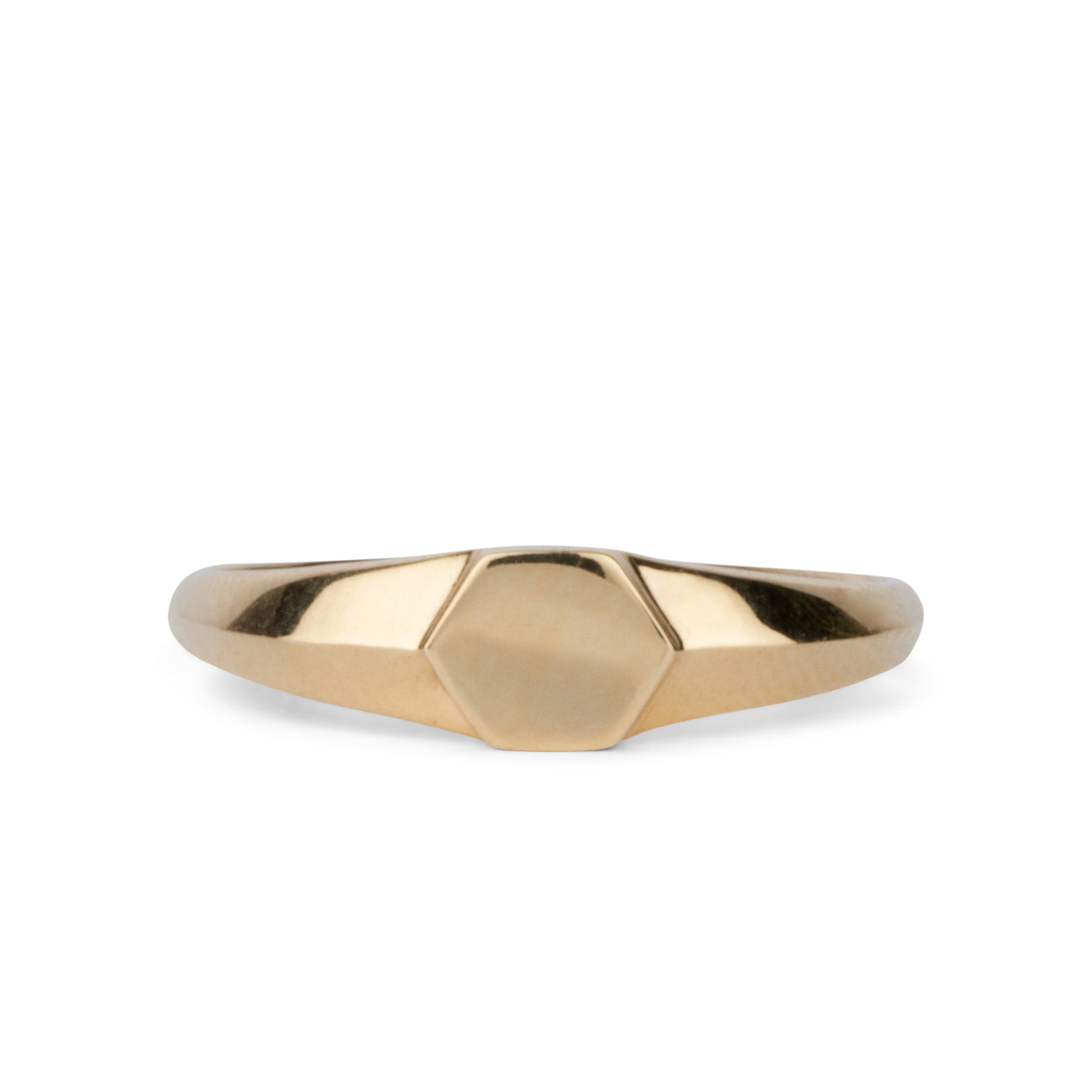 Gold low profile signet ring with a hexagon face on a white background