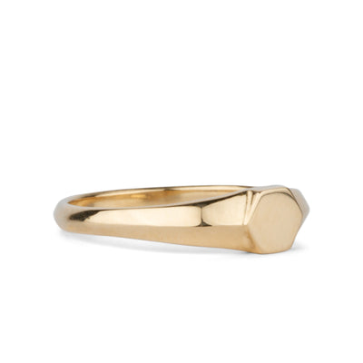 Gold low profile signet ring with a hexagon face alternate side view on a white background
