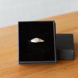 Low profile silver signet ring with hexagon top and engraved single block "L" initial in a gift box