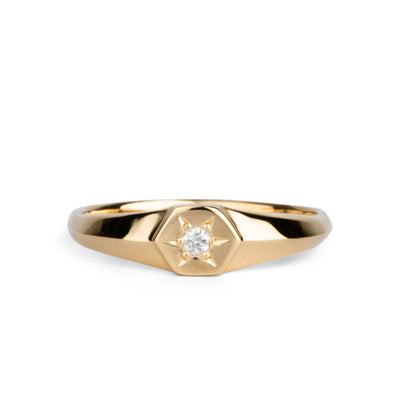 Low profile gold signet ring with hexagon top and a single white diamond set within a six pointed star setting