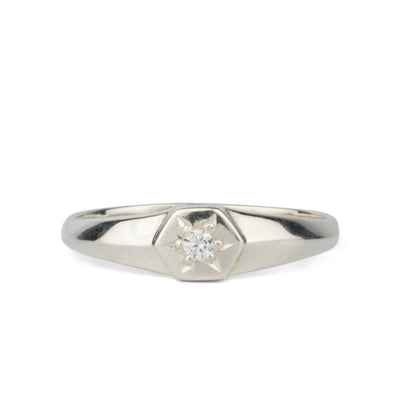 Low profile sterling silver signet ring with a hexagon shaped face and a white center diamond 