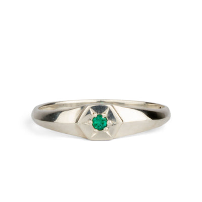 sterling silver hexagon signet ring with a star set emerald in the center on a white background