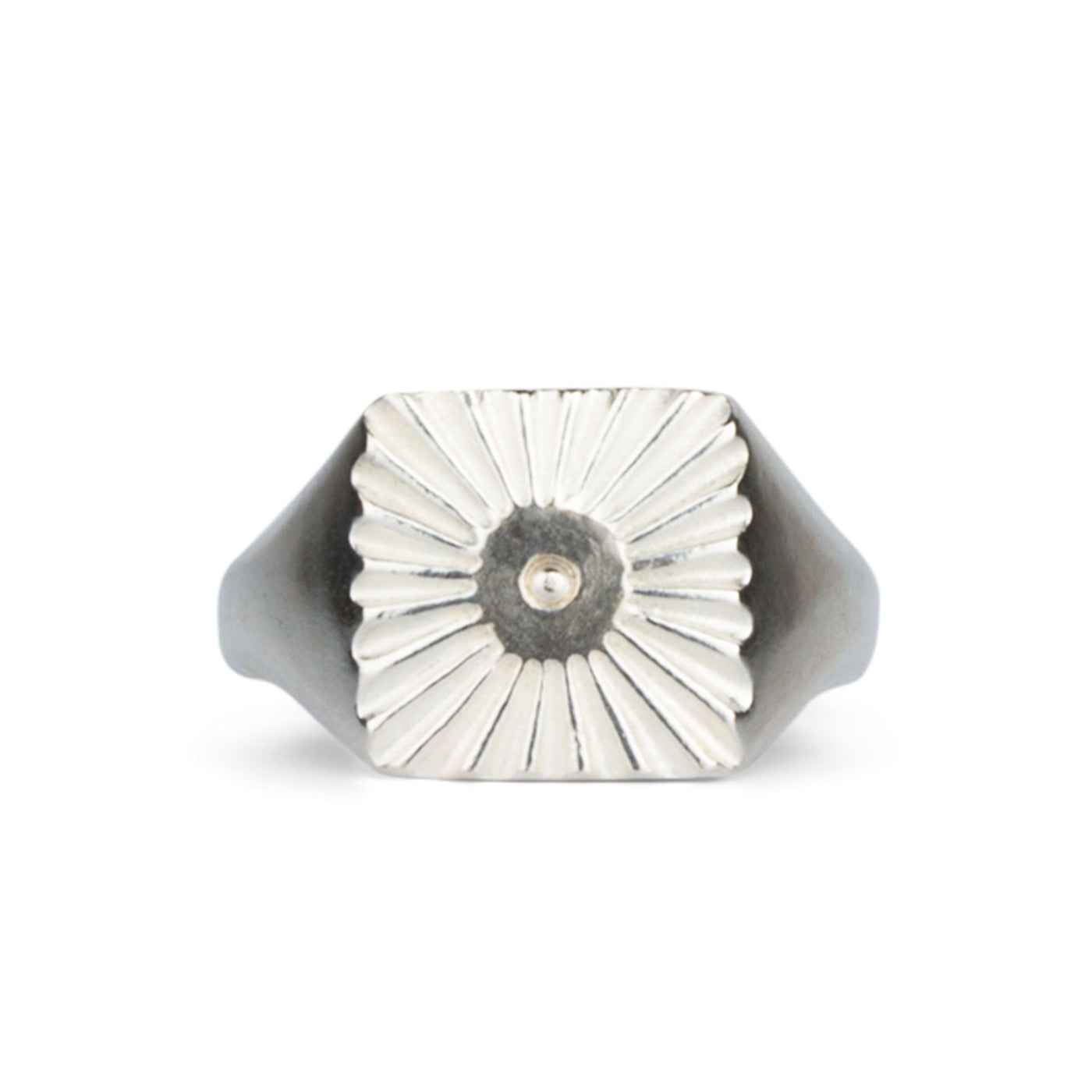 Large silver square signet ring with a carved sunburst pattern and single silver bead in the center on a white background