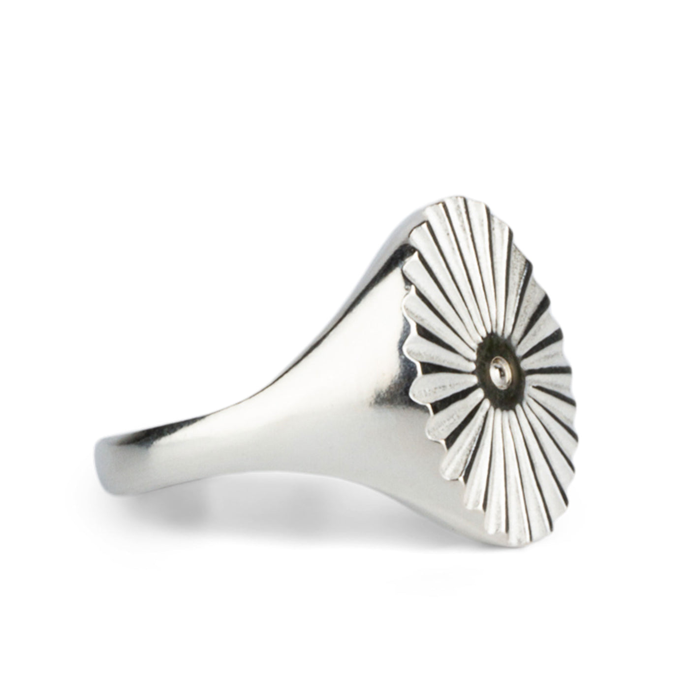 Alternate side view of Large silver oval signet ring with a carved sunburst pattern and a silver bead center on a white background