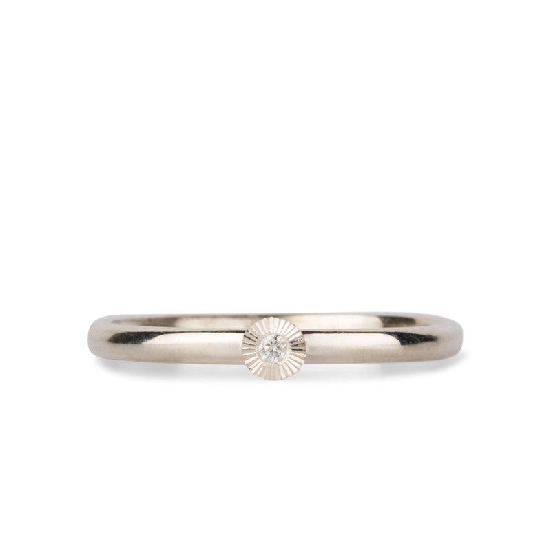sterling silver small aurora stacking ring with a 1.5mm center diamond and engraved border