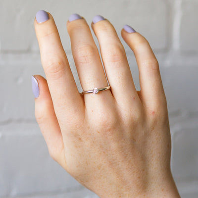 sterling silver large aurora stacking ring with a 3mm center diamond and engraved border on a hand