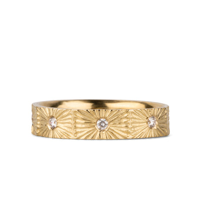 Nova sunburst eternity band with 8 flush set diamonds and carved texture around the outside in 14k yellow gold