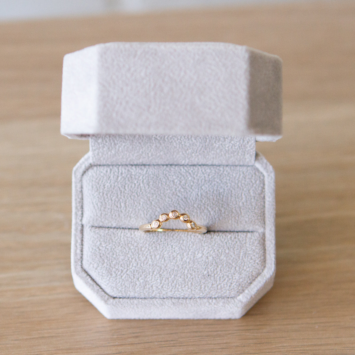Medium Arched Droplet Band Yellow Gold with White Diamonds in a ring box by Corey Egan