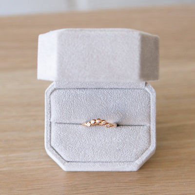 Arched Droplet Band in Rose Gold with White Diamonds in a ring box by Corey Egan