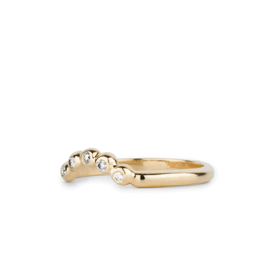 Arched Droplet Band in Yellow Gold with White Diamonds side view on a white backgroundby Corey Egan