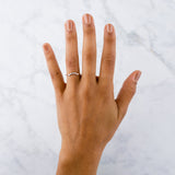 Arched Droplet Band in Rose Gold with White Diamonds on a hand by Corey Egan
