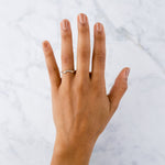 Arched Droplet Band in Yellow Gold with White Diamonds on a hand by Corey Egan