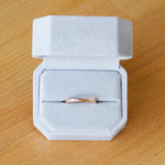 14k rose gold blue ridge half round hammered band in a ring box by Corey Egan