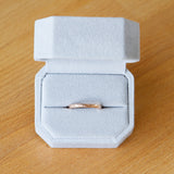 14k rose gold blue ridge half round hammered band in a ring box by Corey Egan