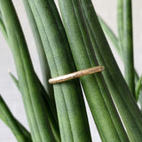 Blue Ridge Half round hammered yellow gold wedding band in natural light