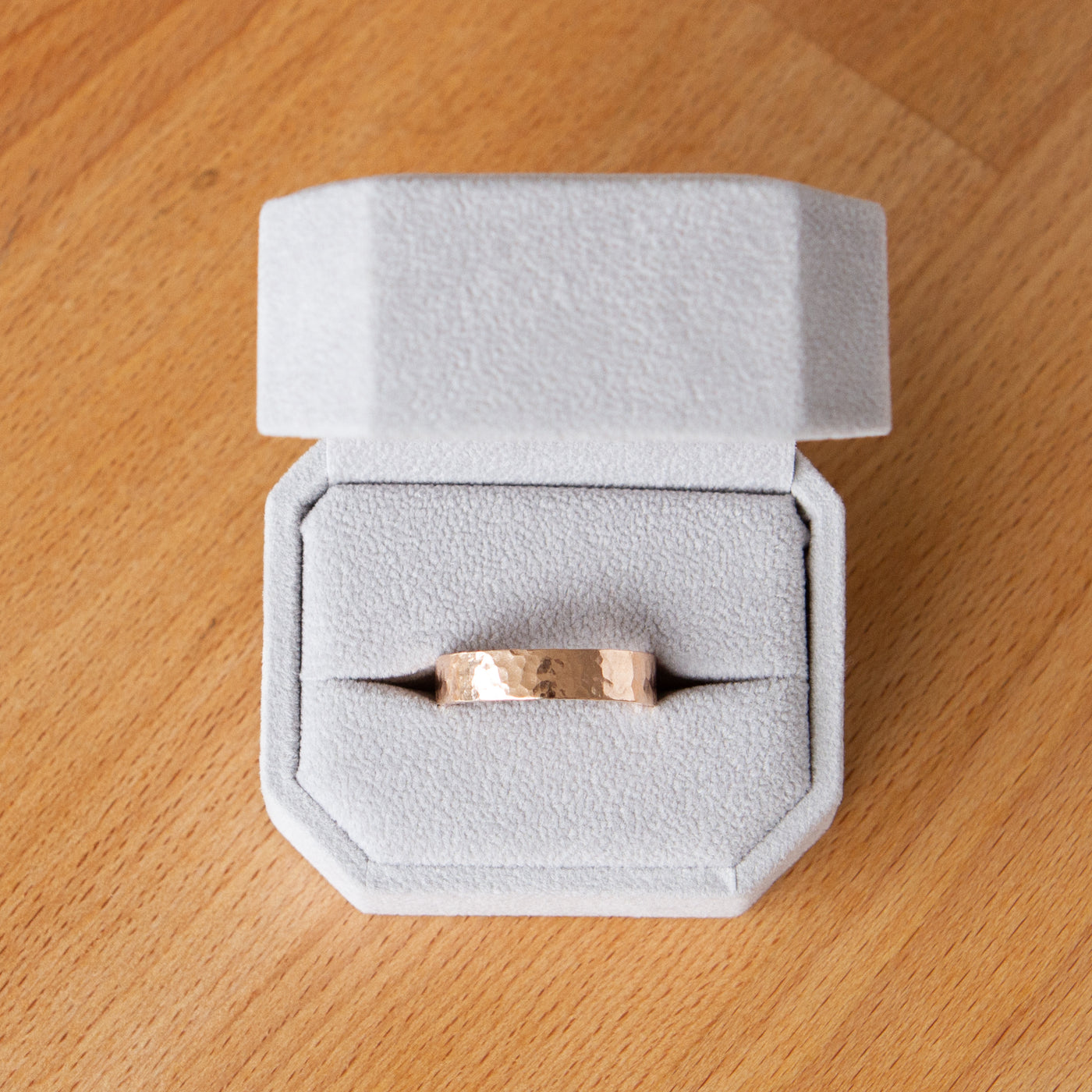 Blue Ridge rose gold flat hammered wedding band in a ring box