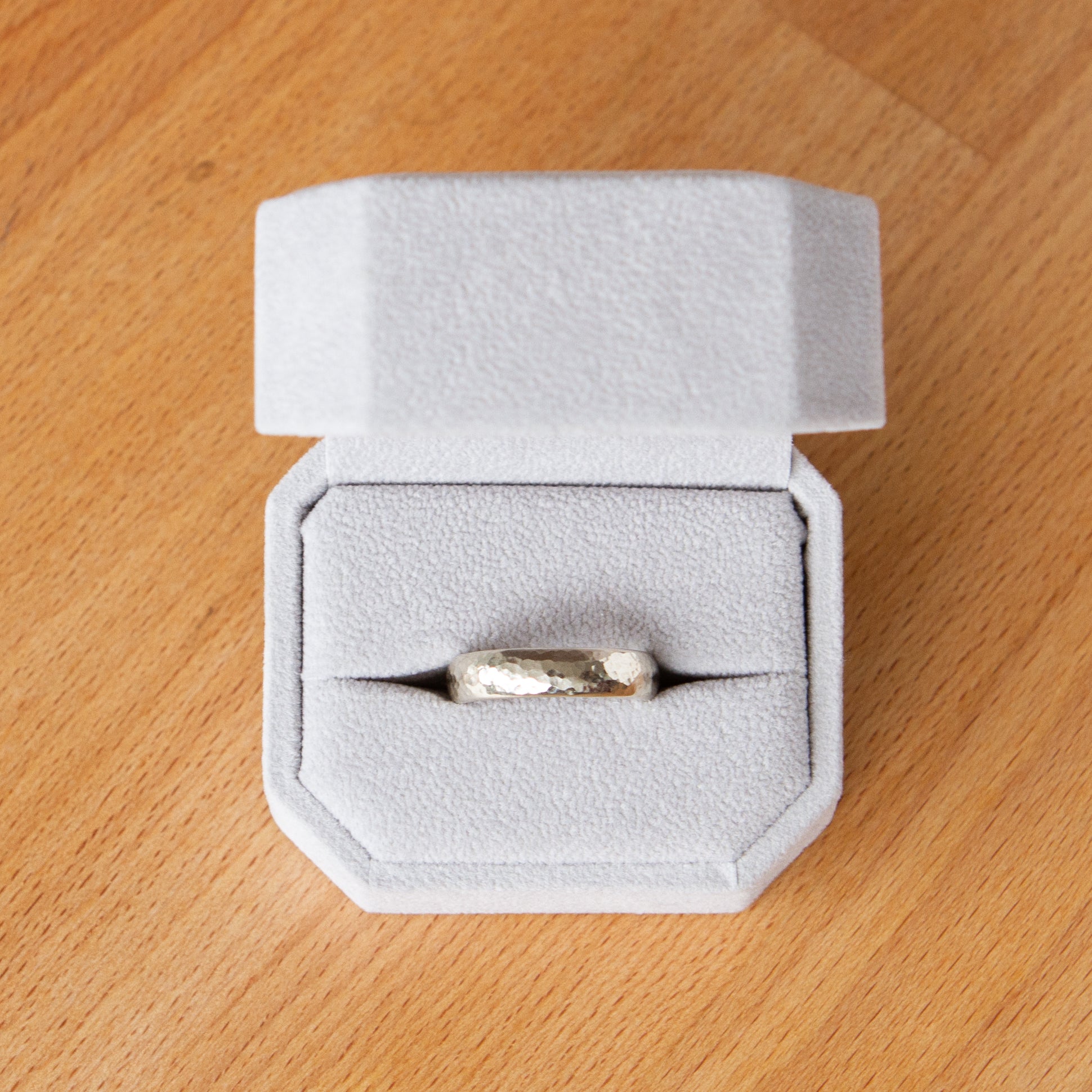 Blue Ridge half round wide white gold wedding band in a ring box