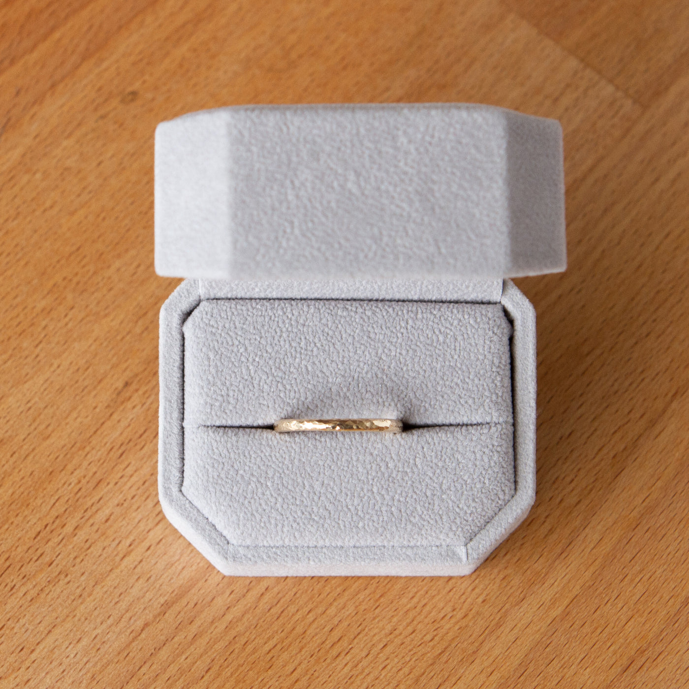 Blue ridge half round hammered yellow gold wedding band in a ring box