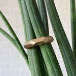 Denali carved chunky faceted yellow gold wedding band in natural light 